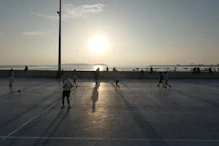 A soccer match in the setting sun
