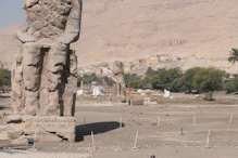 The left statue with a statue behind