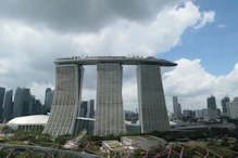 Three buildings joined by a boat on top