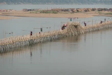 Bamboo bridge rise to let boats through
