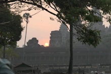The sun appearing behind main temple