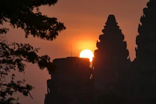 The sun appearing behind main temple