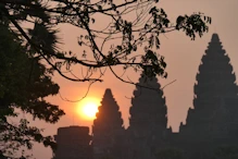 The sun appearing behind main temple