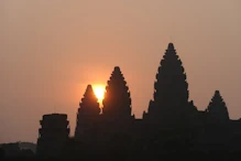 The sun appearing behind main temple