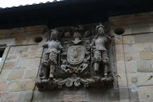 A big shield and supporters on a building