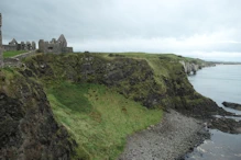 The ruins of the town with the cliffs around th next headland