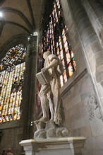 He is depicted without skin and draped in his own skin