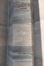 A stone marked with dates of repairs