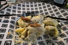 Cheese pasta with a garnish of fried artichoke