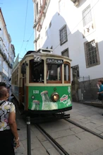 Old style tram going down a steep road