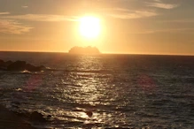 Sun setting behind cruise ship