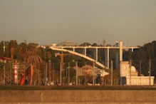 Looking up river to concrete arch bridge