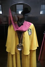 An academic regalia with a wine testing tool