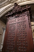Large carved door with lots of grapes