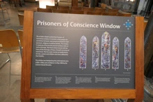 An explanation of the prisoner of concience window behind main altar