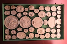 Some of a large collection of plaster cameos of works of art