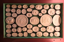 Some of a large collection of plaster cameos of works of art