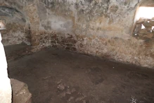 Inside small disused church (note rocks in windows)