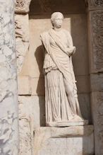 Library wise statue in niche