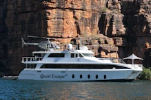 Small boat with helicopter flight over falls
